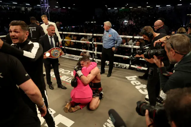 Chris Billam-Smith hugs his wife in the ring