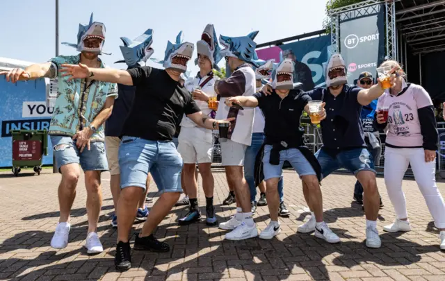 Sale fans in shark masks