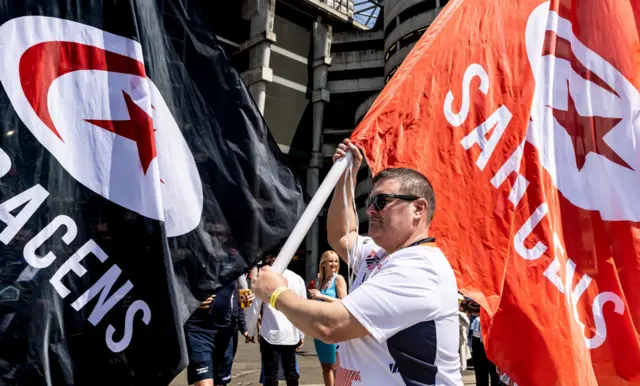 Saracens fan with a huge flag.