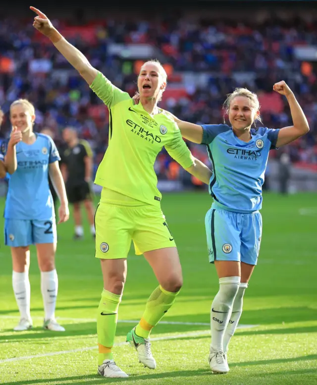 Karen Barsdley and Izzy Christiansen celebrate winning the cup at Wembley.