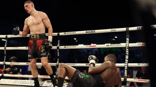 Chris Billam-Smith stands over a floored Lawrence Okolie