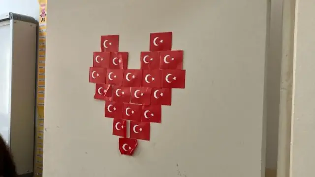 Turkish flags made into the shape of a heart pasted onto the door of a polling station in Ankara