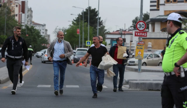 Election officials accompanied by police officers carry bags full of ballots to the provincial election board in Diyarbakir