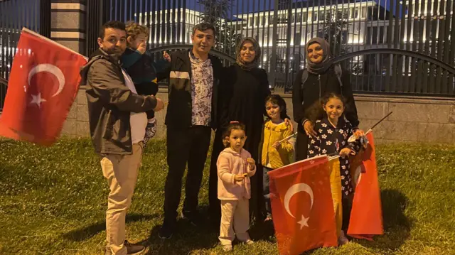 Friends and family gather outside gates in Turkey