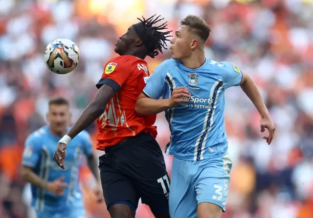 Luton Town's Elijah Adebayo in action with Coventry City's Callum Doyle