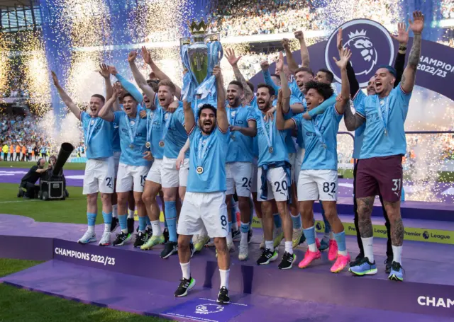 Man City celebrate with the Premier League trophy