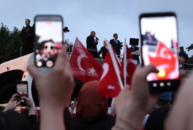 Supporters hold up phones to record Erdogan speech