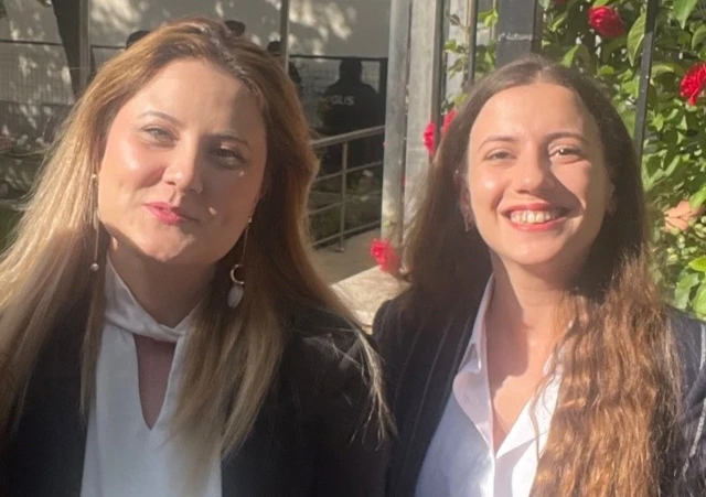 Sena and Gokce. Both young women are smiling and are standing outside in the sun.