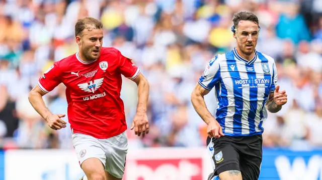 Lee Gregory shields the ball from a Barnsley defender