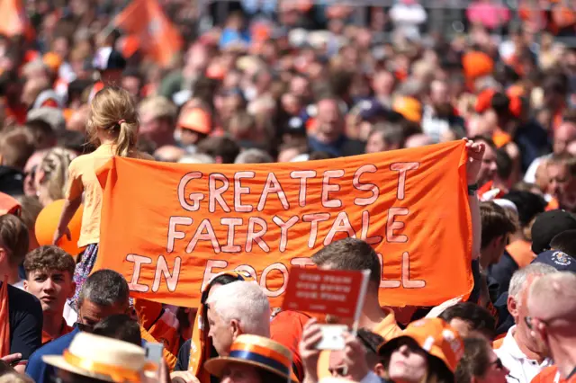 'The greatest achievement in football' banner in a crowd of Luton Town fans