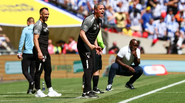 Managers shout on the touchline