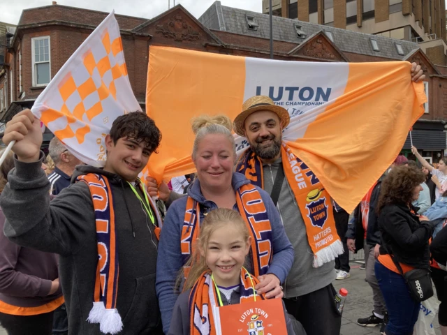 Kylie and Mem and children Ayden and Chloe, wearing Luton scarves and flying Luton flags