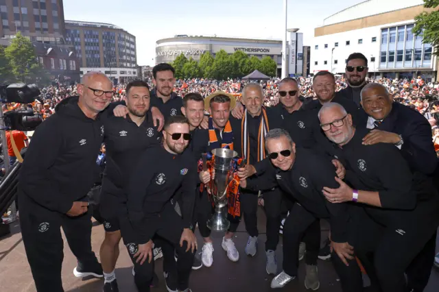 Luton Town staff celebrate promotion at St George's Square in Luton