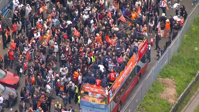 Helicopter shot of buses as they leave Kenilworth Road