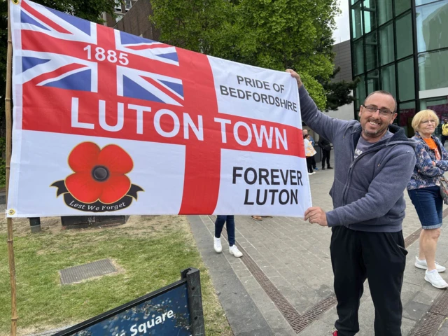 David Leete holding an England flag with Luton Town, Forever Luton and Pride of Bedfordshire written on it