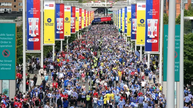 Fans walk towards Wembley