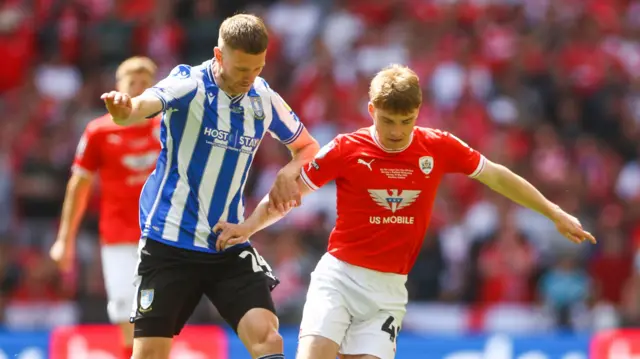 Barnsley and Sheffield Wednesday players challenge for the ball