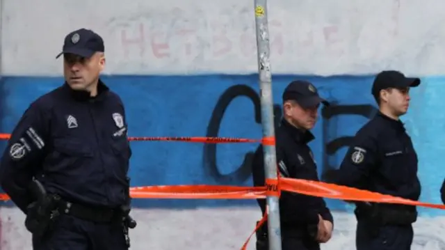 Police officers secure the area after a 14-year-old boy opened fire on other students and security guards at a school in downtown Belgrade, Serbia, May 3, 2023