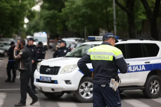 Police officers block a street near the Vladislav Ribnikar elementary school