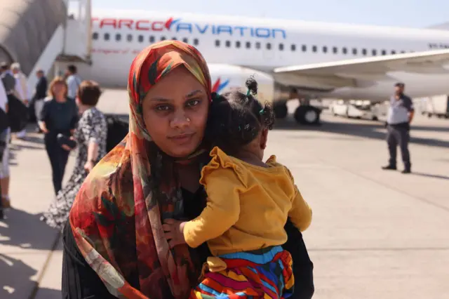 People fleeing conflict in Sudan arrive at an airport in Abu Dhabi after an evacuation flight, on April 29, 2023