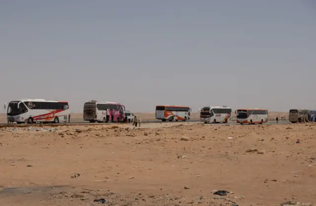 A line of buses outside a bus stop near Aswan, Egypt. April 27, 2023