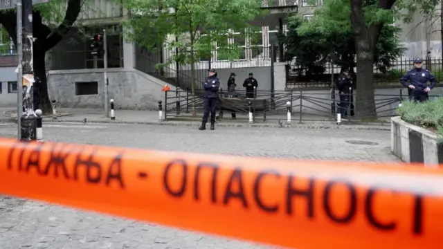 Police officers guard the school entrance following a shooting at a school in the capital Belgrade on May 3, 2023.