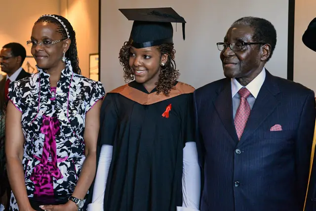 Robert Mugabe (R) and his wife Grace (L) with their 24-year-old first-born child and only daughter Bona Mugabe (C) pose after the convocation at MDIS-University of Wales graduation ceremony in Singapore on November 16, 2013