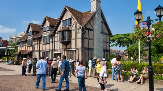 A tourist group waiting in front of Shakespeare's Birthplace at Henley Street. Shakespeare's Birthplace