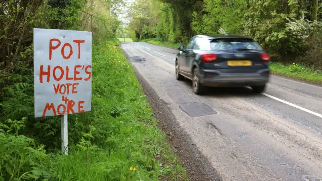 Vote potholes sign