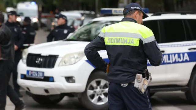 Police officers block a street near the Vladislav Ribnikar elementary school in Belgrade