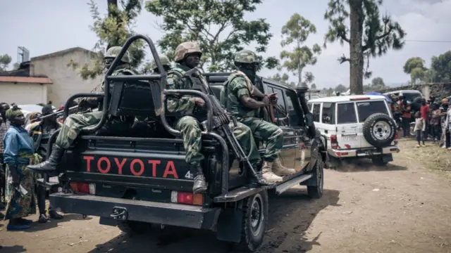 The security escort of the governor of North Kivu province, General Constant Ndima (not seen), prepares to leave an informal camp for displaced people who fled the advance of the M23 (March 23 Movement) rebellion in Kanyaruchinya, the northern district of Goma, on November 2, 2022.