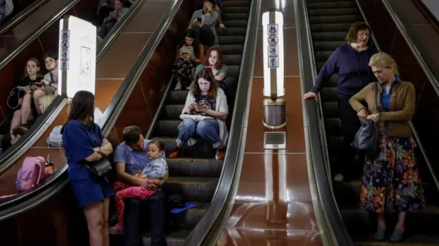 People take shelter in a Kyiv Metro station