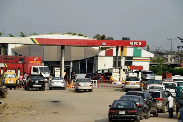 Motorists queue to buy fuel at a filling station in Nigeria