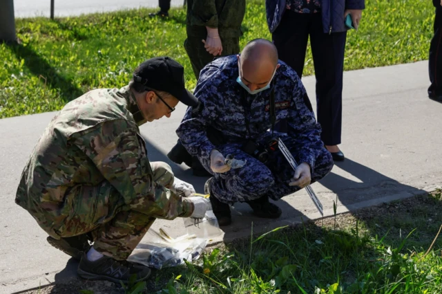 Investigators check the scene after drones were shot down over Moscow