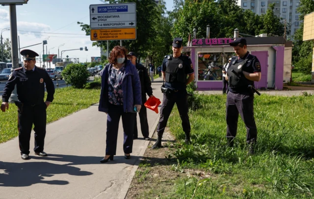 Police officers stand on the outskirts of Moscow