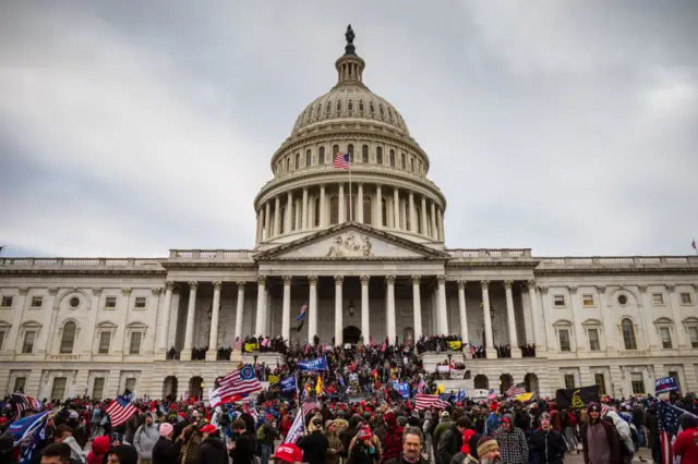 A large group of pro-Trump protesters stand on the East steps of the Capitol Building after storming its grounds on January 6, 2021 in Washington, DC.