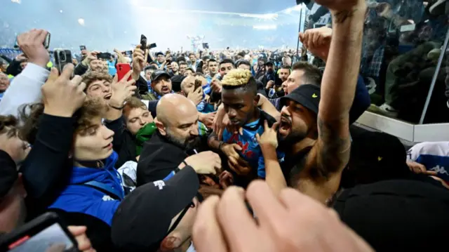 Victor Osimhen surrounded by supporters