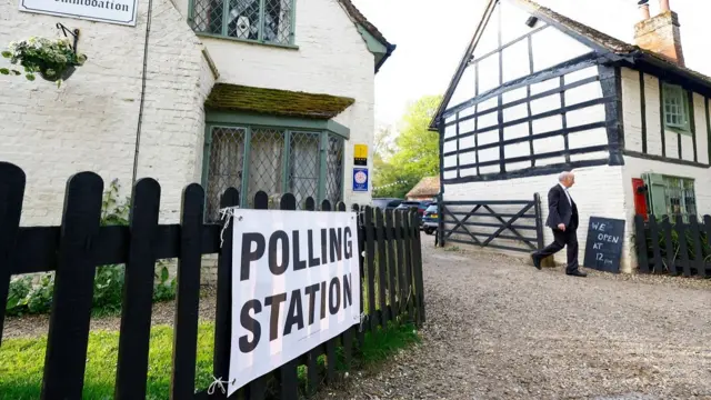 A man walks near a venue which is acting as a polling station for local elections in Ayot St Lawrence,