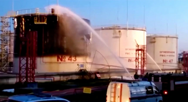 Firefighters working to extinguish the fire at the oil refinery