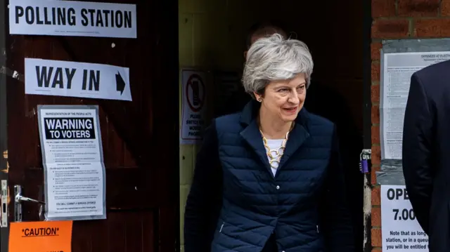 Theresa May leaves a polling station