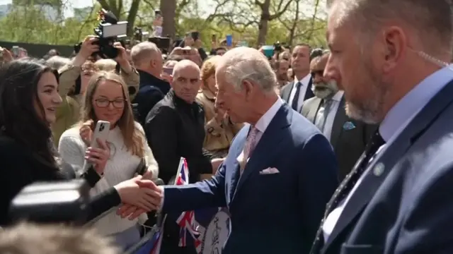 Charless greets woman