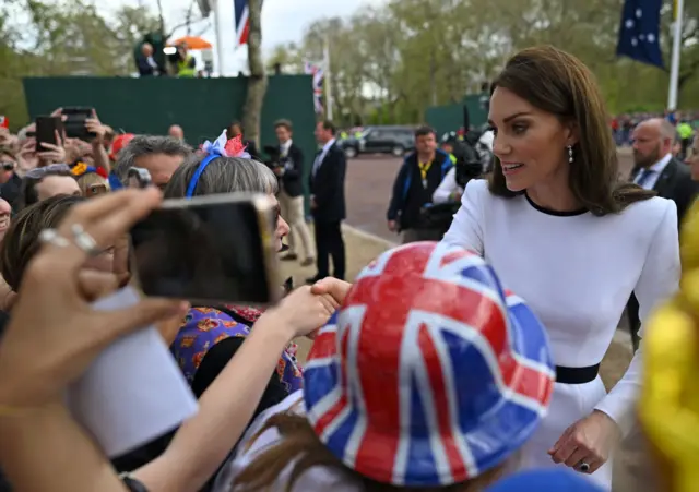 Catherine greets people