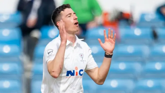 Matt Fisher reacts after bowling for Yorkshire