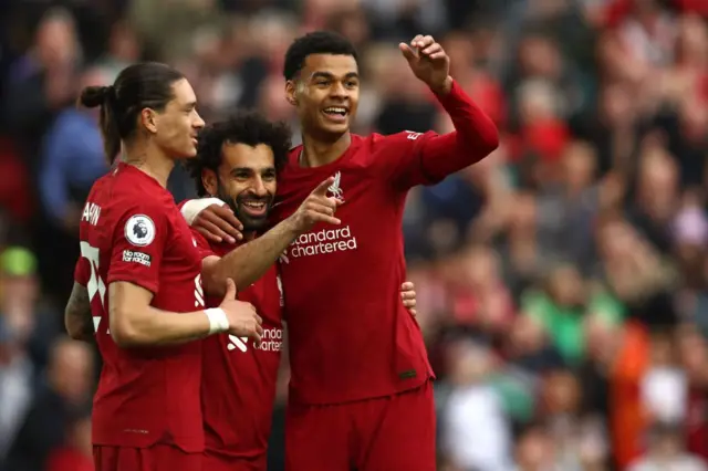 Darwin Nunez and Cody Gakpo celebrate with Mohamed Salah after he opens the scoring