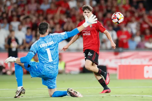 Real Madrid's goalkeeper Thibaut Courtois (L) in action against Osasuna's Ez Abde during the Spanish King's Cup soccer final match between Real Madrid and CA Osasuna, in Seville, southern Spain, 06 May 2023.