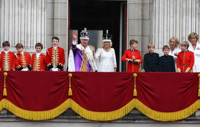 Britain's King Charles and Queen Camilla wave on the Buckingham Palace balcony following their coronation ceremony