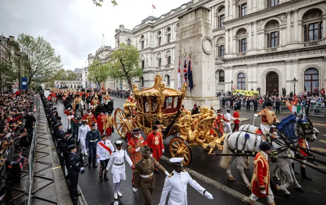 King Charles III and Queen Camilla travelling in the Gold State Coach