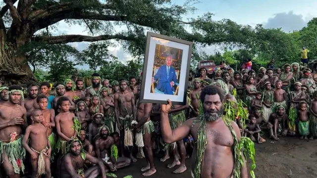 Villagers from Iaohnanen and Yakel on Vanuatu's Tanna island pose with a portrait of Britain's King Charles III on May 6