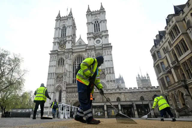 People sweep sand outside Westminster Abbey