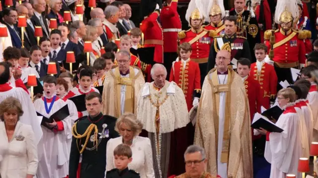 Charles walks up the abbey